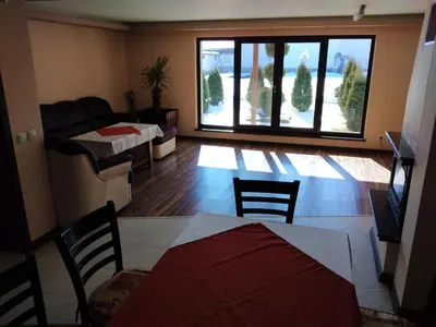 a living room with a table and chairs and a couch at Sveti Nikola Villas near Borovets in Shiroki Dol