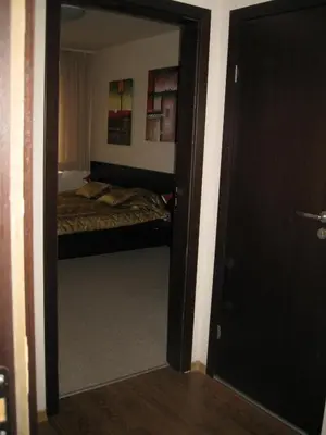 a bedroom with a door leading to a bed at Spacious and Cosy Apartment in Bansko Royal Towers Complex in Bansko