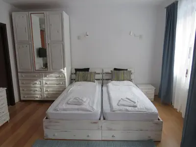 a bedroom with two beds and a dresser and a mirror at Flora Violet Studio Apartment nr 10 in Borovets