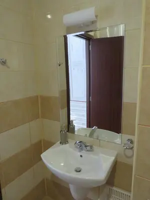 a bathroom with a sink and a mirror at Flora Violet Studio Apartment nr 10 in Borovets