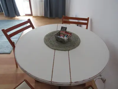 a white dining room table with two chairs and a box on it at Flora Violet Studio Apartment nr 10 in Borovets
