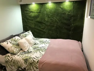 a bed in a room with a green wall at Top Center Vintage Sofia Condo in Sofia