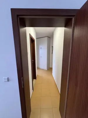 an empty hallway with a hallway leading to a room at Relax&Ski apartment in Bansko