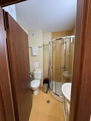 a bathroom with a toilet and a shower and a sink at Relax&Ski apartment in Bansko