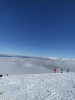 a group of people skiing down a snow covered slope at Relax&Ski apartment in Bansko