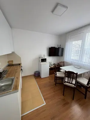 a kitchen and living room with a table and chairs at Relax&Ski apartment in Bansko