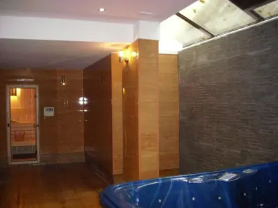 a large bathroom with a blue tub in a room at Apartament Fantasy Hisarya in Hisarya