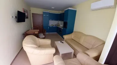 a living room with two couches and a table at Apartament Fantasy Hisarya in Hisarya