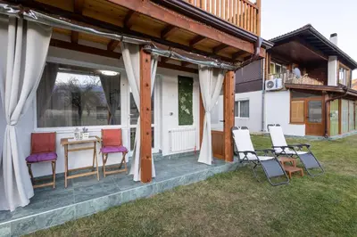 a porch of a house with chairs and a table at Villa Nikol Apt #1 in Raduil