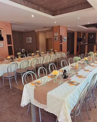 a row of tables and chairs in a room at Почивна база 