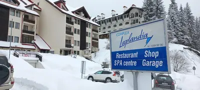 a sign for a ski centre garage in the snow at Мезонет Лапландия in Pamporovo