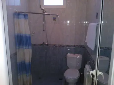 a bathroom with a shower and a toilet at Hotel Tsarevets in Asenovgrad
