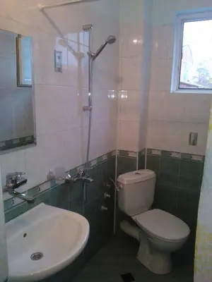a bathroom with a toilet and a sink at Hotel Tsarevets in Asenovgrad