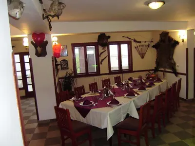 a dining room with a long table and chairs at Family Hotel Diana in Lyaskovo