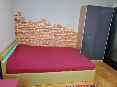 a bed in a room with a brick wall at Романтично Място Ани in Plovdiv