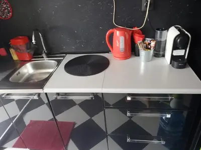 a small kitchen with a sink and a counter top at Романтично Място Ани in Plovdiv