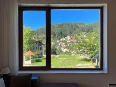 a window in a room with a view of a town at Ani's Guest House in Chepelare
