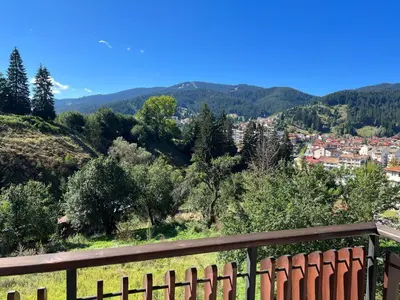 a view of a city from a hill with a fence at Ani's Guest House in Chepelare