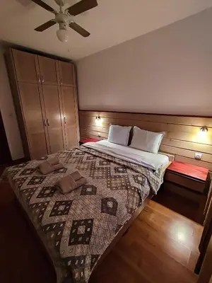 a bedroom with a bed and a ceiling fan at Belvedere Holiday Club К501 in Bansko