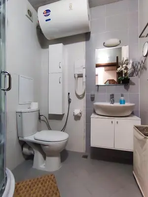 a white bathroom with a toilet and a sink at Belvedere Holiday Club К501 in Bansko
