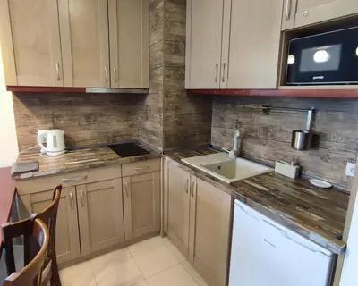 a small kitchen with a sink and a microwave at Belvedere Holiday Club К501 in Bansko