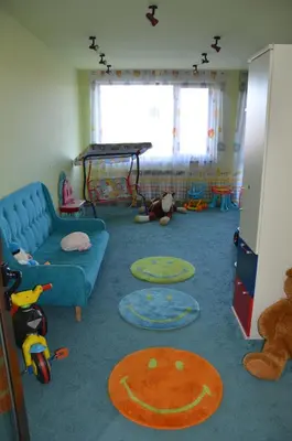 a living room with a blue couch and toys at Belvedere Holiday Club К501 in Bansko