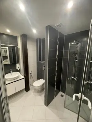 a bathroom with a toilet and a sink and a shower at Hotel Darling in Bankya