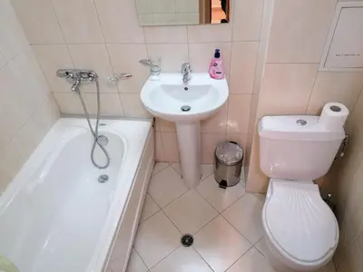 a bathroom with a sink and a toilet and a bath tub at Pirin place private apartment in Bansko
