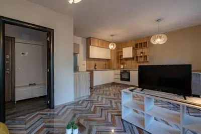 a large kitchen with a tv on a table at Bright 1BDR Apartment with a Balcony in Sofia