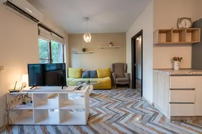 a living room with a tv on a table at Bright 1BDR Apartment with a Balcony in Sofia