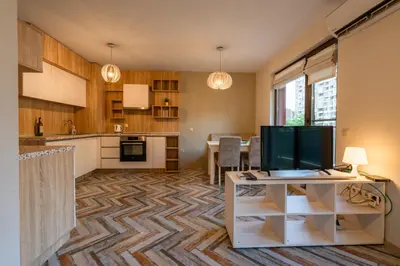 a living room with a kitchen and a dining room at Bright 1BDR Apartment with a Balcony in Sofia
