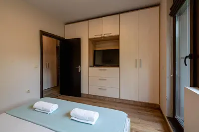 a bedroom with a bed with two towels at Bright 1BDR Apartment with a Balcony in Sofia