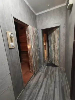 a hallway with two open doors in a room at Homey art apartment next to Drujba lake Metro stations and bul.Tsarigradsko Shose in Sofia