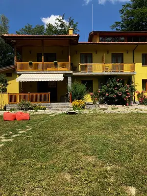 a yellow house with a yard in front of it at Вила Ренесанс Костенец in Kostenets Village