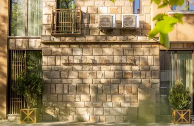 a brick wall with two potted plants on it at HIDDEN BANK: First Million in Plovdiv