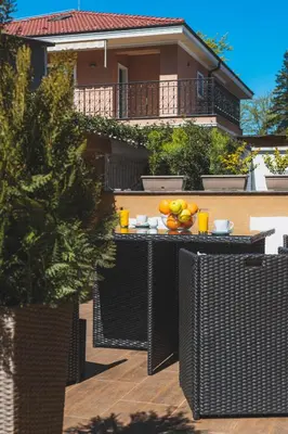a table with fruit on it in front of a house at HIDDEN BANK: First Million in Plovdiv