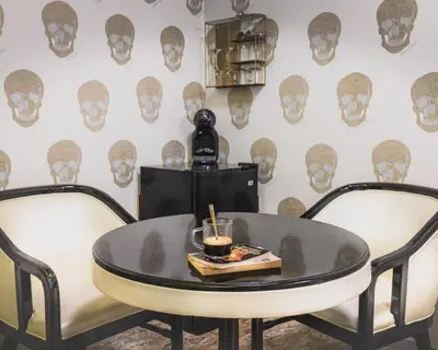 a table with a drink and two chairs at HIDDEN BANK: First Million in Plovdiv