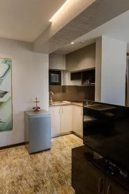 a kitchen with white cabinets and a cross on the wall at HIDDEN BANK: Cash in Plovdiv
