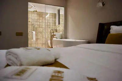a bathroom with a bed and a tub and a sink at HIDDEN BANK: Cash in Plovdiv