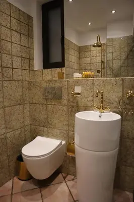 a bathroom with a toilet and a sink at HIDDEN BANK: Cash in Plovdiv