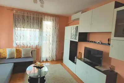 a living room with a couch and a television at Mia's Apartment, Stylish one-bedroom apartment in Sofia