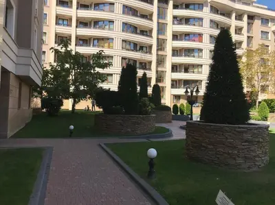 a large apartment building with trees in front of it at Mia's Apartment, Stylish one-bedroom apartment in Sofia