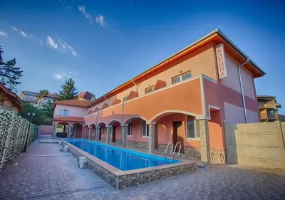 a building with a swimming pool in front of it at Айляк Клуб Велинград - Бутиков Хотел&СПА с Elegant Ultra All Inclusive in Velingrad