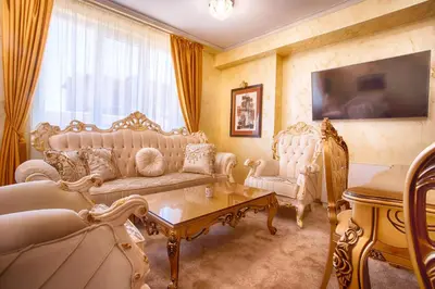 a living room with two couches and a table at Айляк Клуб Велинград - Бутиков Хотел&СПА с Elegant Ultra All Inclusive in Velingrad