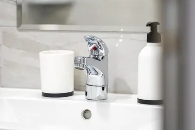 a bathroom sink with a faucet and two rolls of toilet paper at WOW studios for rent - bul Montevideo 25A - B in Sofia