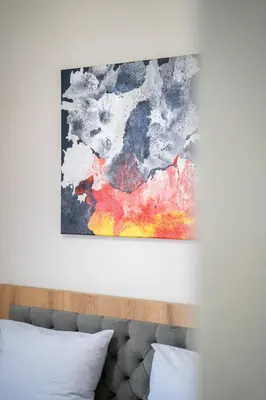 a painting on a wall above a bed at WOW studios for rent - bul Montevideo 25A - B in Sofia