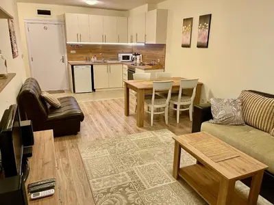 a living room with a couch and a table at Pirin Dream View Apartments in Razlog