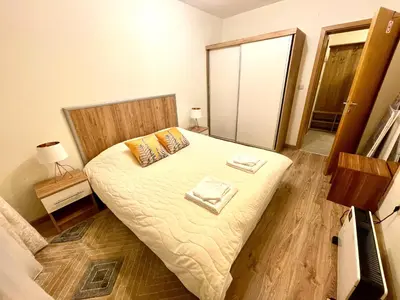 a bedroom with a bed with two towels on it at Pirin Dream View Apartments in Razlog