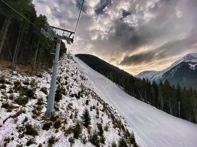 a ski lift on a snow covered slope with trees at CEDAR LODGE NEXT TO LIFT ONE BEDROOM APARTMENT in Bansko