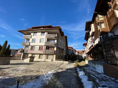 an apartment building in a city with snow on the ground at CEDAR LODGE NEXT TO LIFT ONE BEDROOM APARTMENT in Bansko